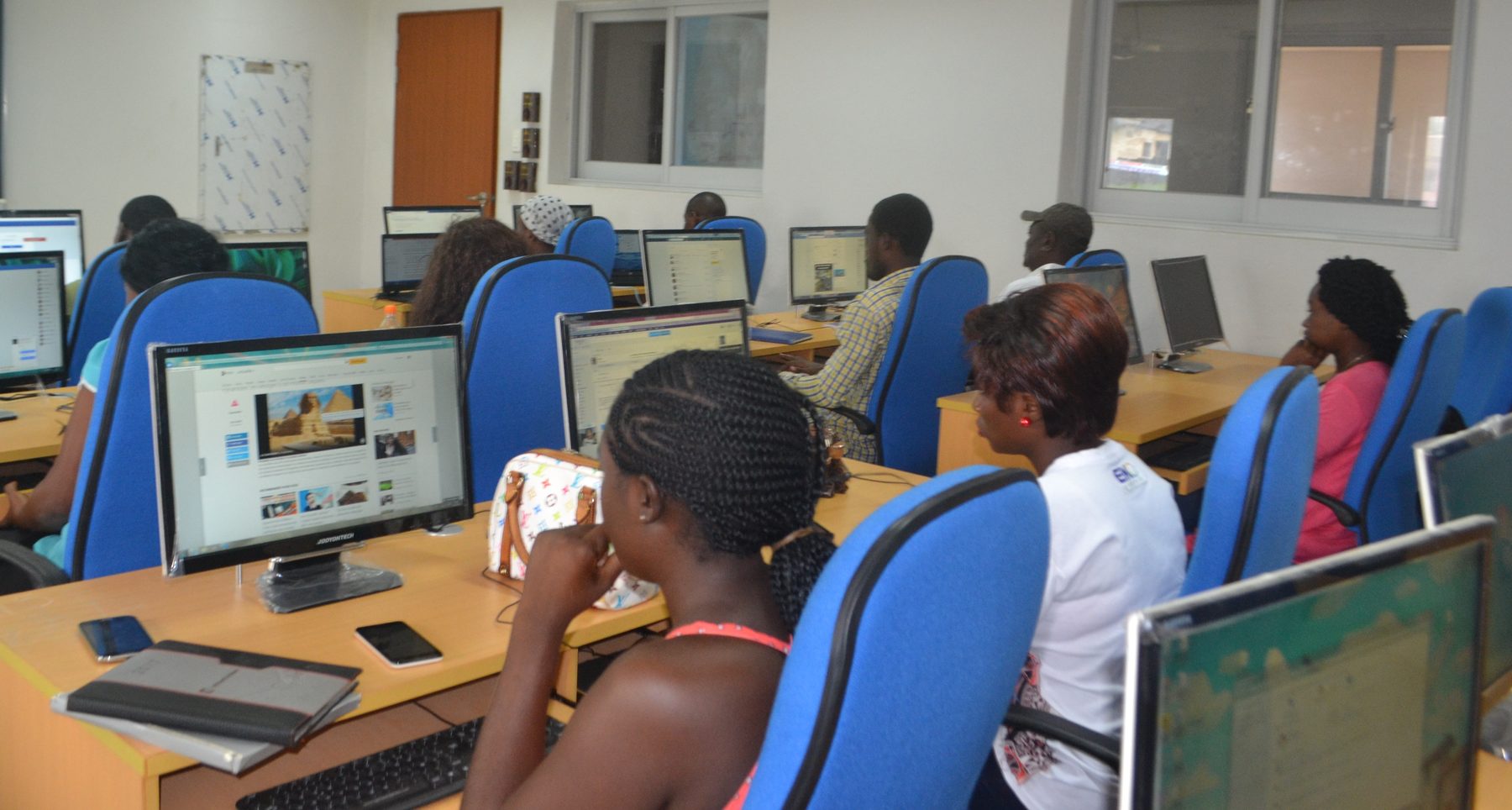 African professionals using computers in a workplace in Cameroon